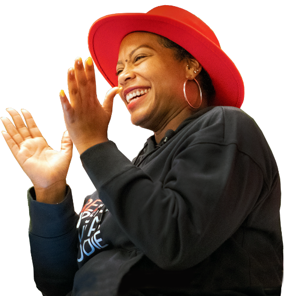Smiling woman in a red hat applauding